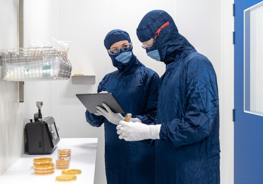 Validation engineers reviewing data in a cleanroom